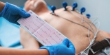Electrocardiogram,,Ecg,In,Hand.,Cardiogram,Printout,On,Male,Patient,Background Electrocardiogram,,Ecg,In,Hand.,Cardiogram,Printout,On,Male,Patient,Background